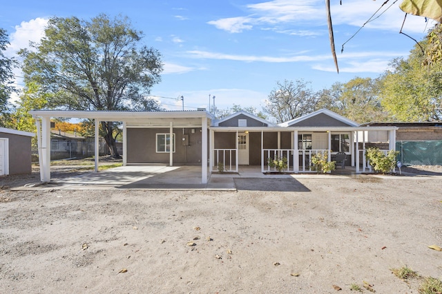 back of property with a sunroom and a carport