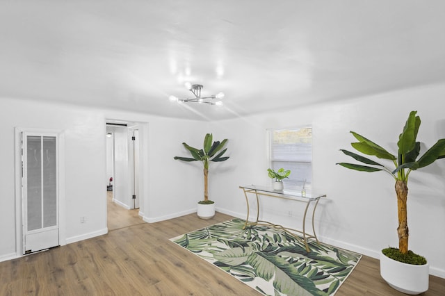 interior space with hardwood / wood-style floors and a notable chandelier