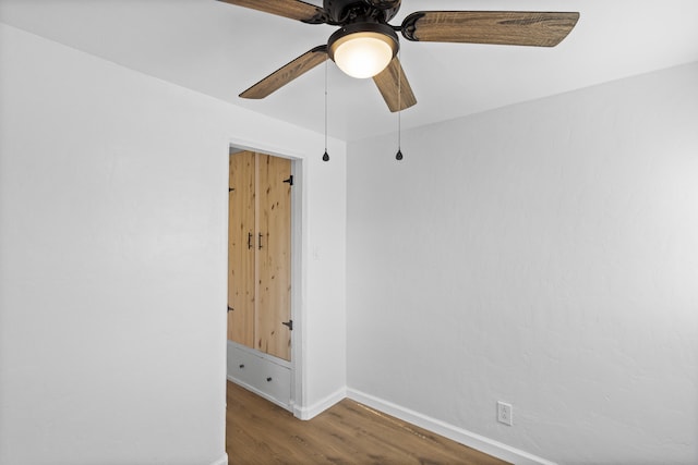 empty room featuring hardwood / wood-style floors and ceiling fan