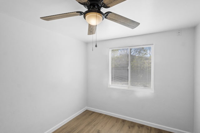 spare room with hardwood / wood-style flooring and ceiling fan