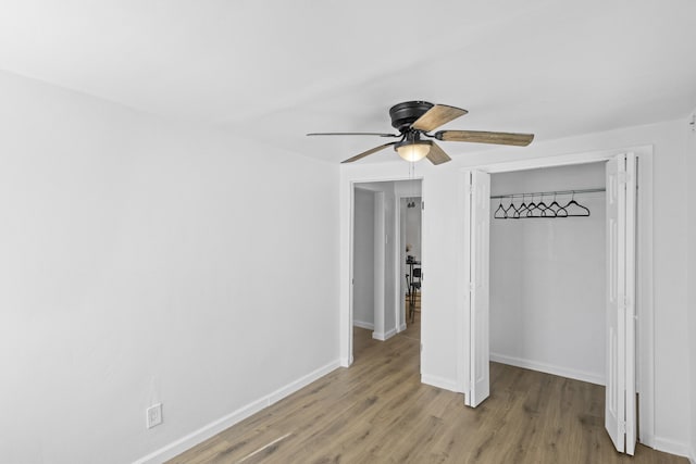 unfurnished bedroom with ceiling fan, a closet, and light hardwood / wood-style flooring