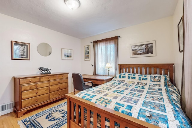 bedroom with hardwood / wood-style floors