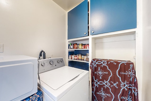 laundry area with cabinets and separate washer and dryer