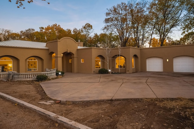 mediterranean / spanish home featuring a garage