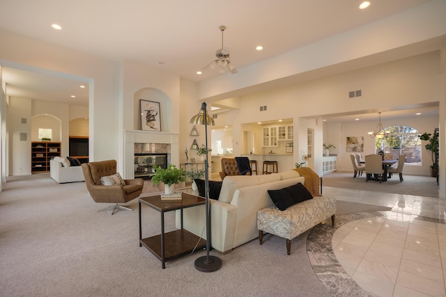 living room featuring a chandelier and a high end fireplace