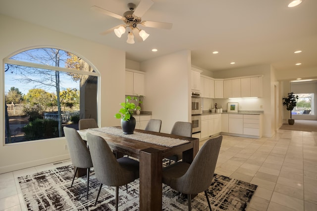 dining space featuring ceiling fan and light tile patterned flooring