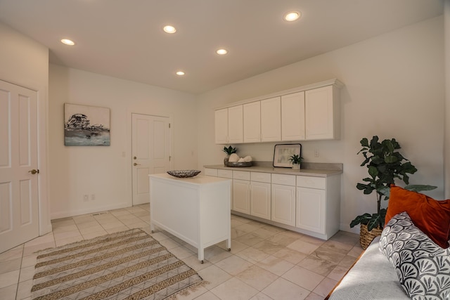 kitchen with a center island and white cabinets