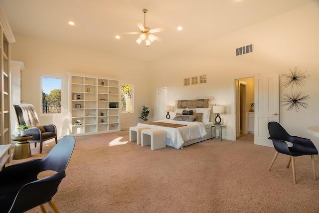 carpeted bedroom featuring ceiling fan and a towering ceiling