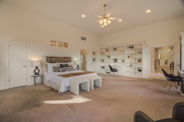 carpeted bedroom featuring a towering ceiling and ceiling fan