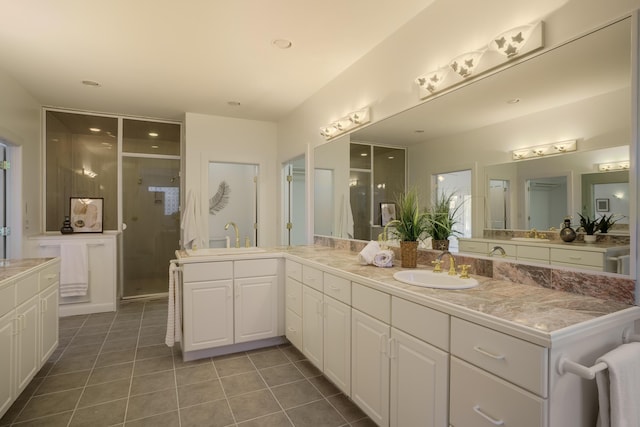 bathroom featuring walk in shower, vanity, and tile patterned flooring