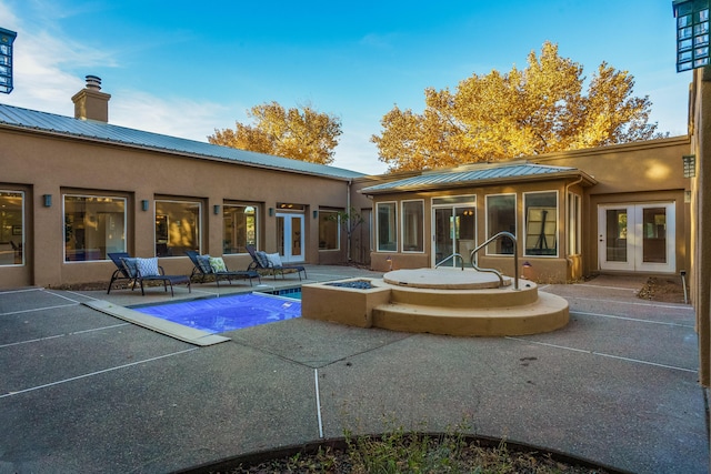 back of property with french doors and a patio area