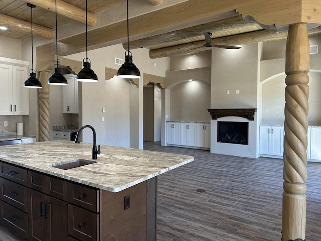 kitchen featuring sink, wood ceiling, light stone counters, white cabinets, and decorative light fixtures