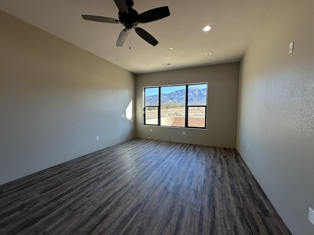 unfurnished room featuring ceiling fan and dark hardwood / wood-style flooring