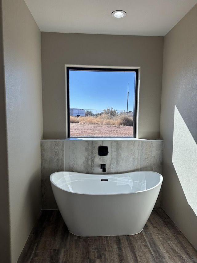 bathroom featuring hardwood / wood-style floors and a tub