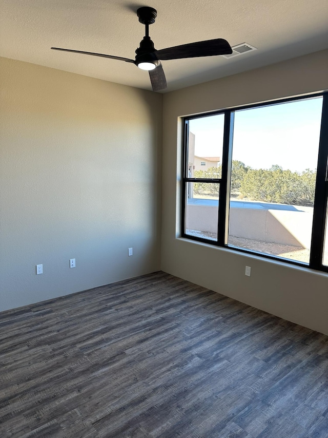 spare room featuring dark hardwood / wood-style flooring and ceiling fan