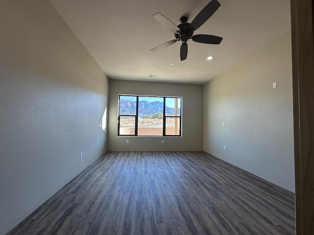 unfurnished room featuring ceiling fan and dark hardwood / wood-style floors