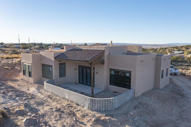 back of property with a patio area