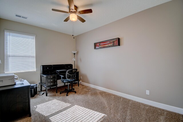 home office with light carpet and ceiling fan