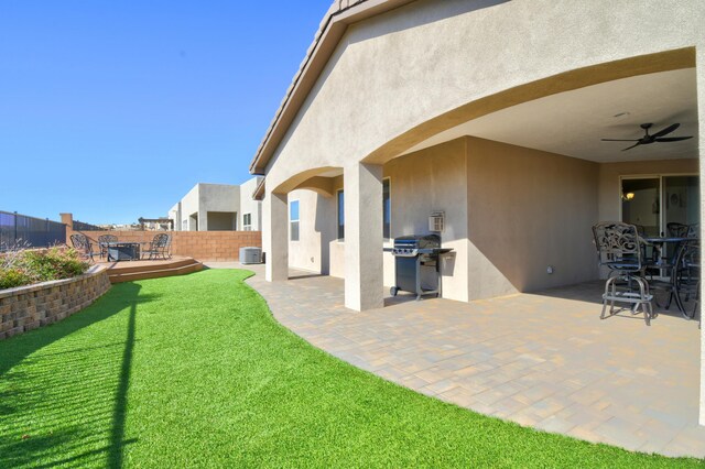 view of yard featuring a patio, a deck, ceiling fan, and cooling unit