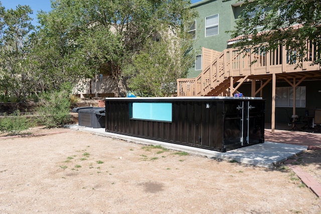 view of gate featuring a patio and a deck