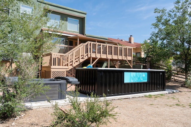 rear view of house featuring a deck