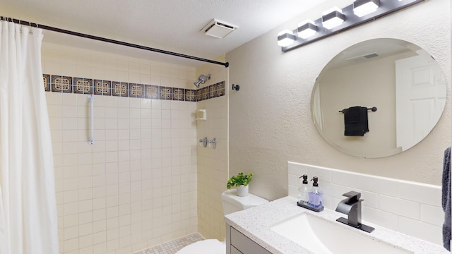 bathroom featuring vanity, backsplash, toilet, a textured ceiling, and walk in shower