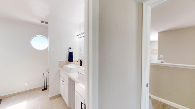 bathroom featuring tile patterned flooring and vanity