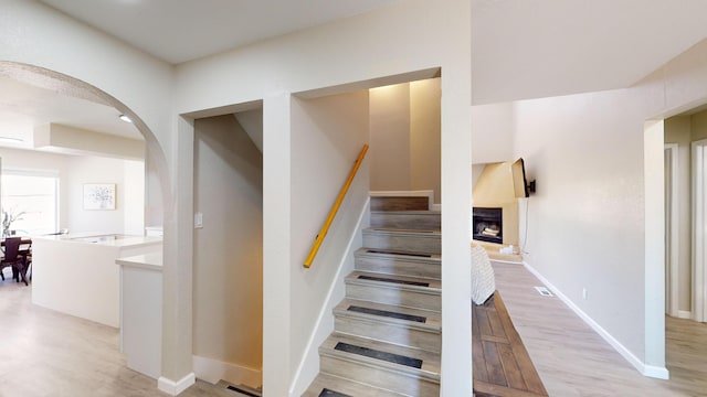 stairs featuring hardwood / wood-style floors