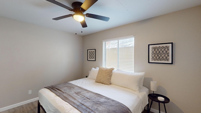 bedroom with wood-type flooring and ceiling fan