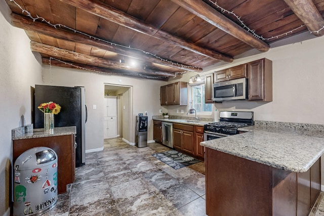 kitchen with appliances with stainless steel finishes, wooden ceiling, a sink, and beam ceiling