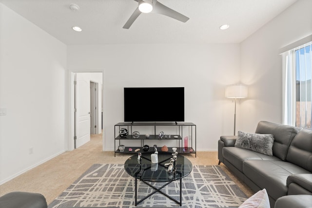 carpeted living room with ceiling fan