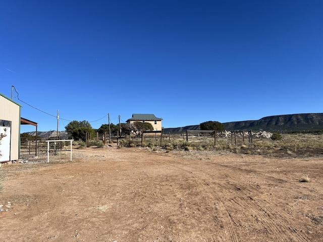 view of yard with a mountain view and a rural view