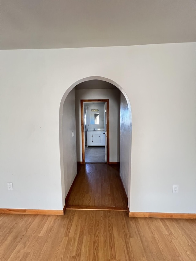 corridor with hardwood / wood-style floors