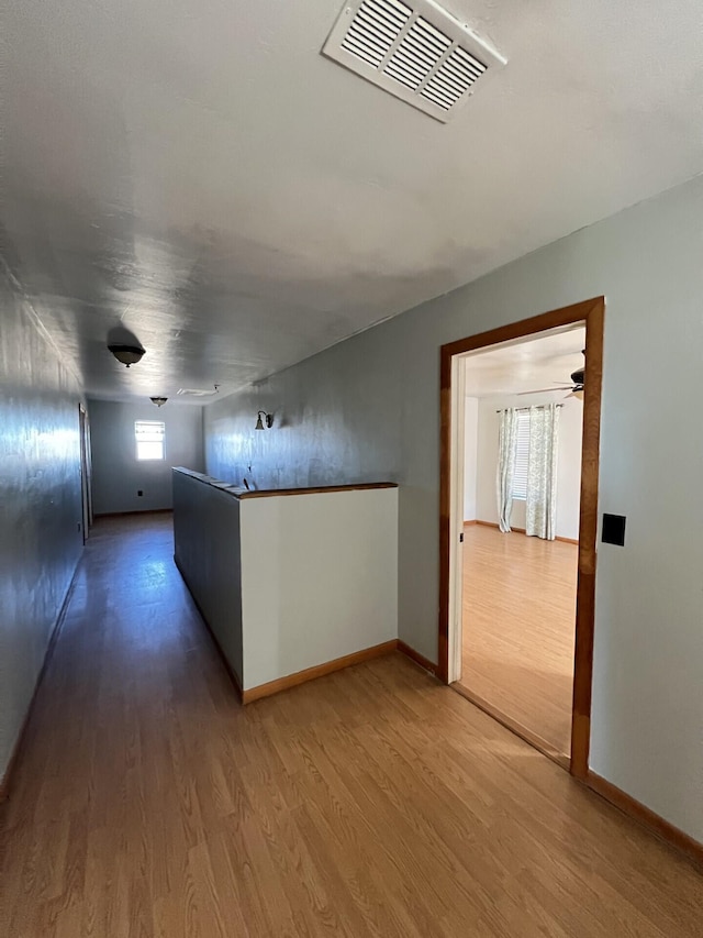 hallway with wood-type flooring