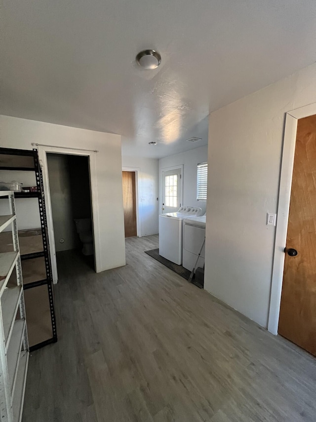 interior space with wood-type flooring and independent washer and dryer