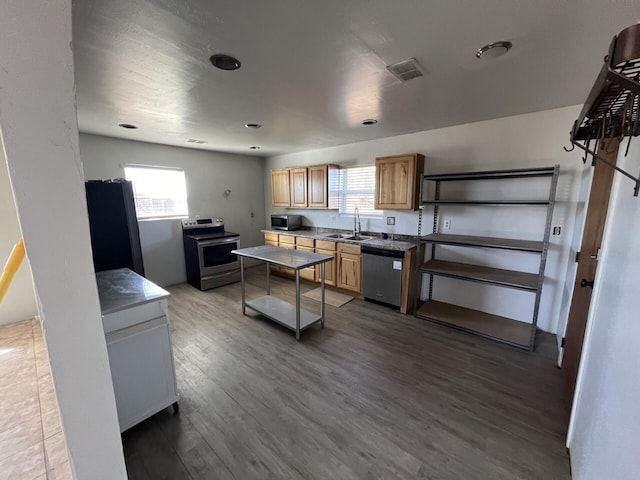 kitchen featuring hardwood / wood-style flooring, sink, and stainless steel appliances