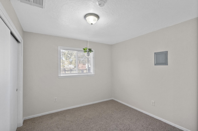 unfurnished bedroom featuring carpet flooring, a textured ceiling, and a closet