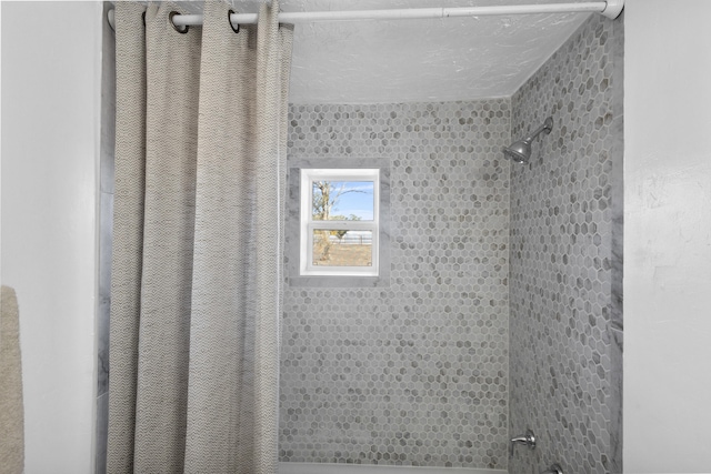 bathroom with tiled shower