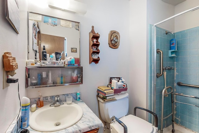 bathroom featuring tiled shower, vanity, and toilet