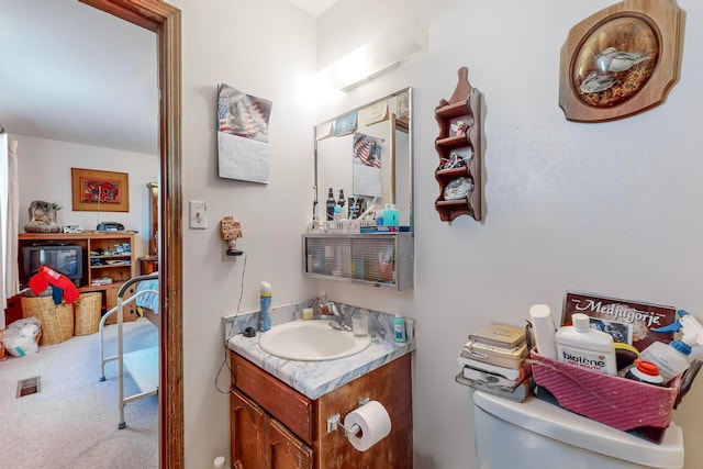 bathroom featuring vanity and toilet