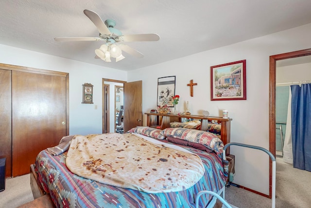 bedroom with ceiling fan, a closet, and light colored carpet