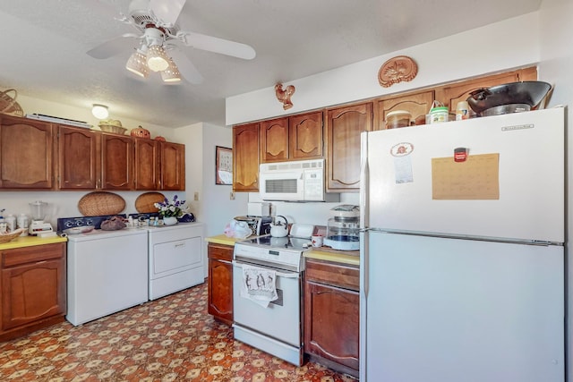 kitchen with ceiling fan, white appliances, and independent washer and dryer