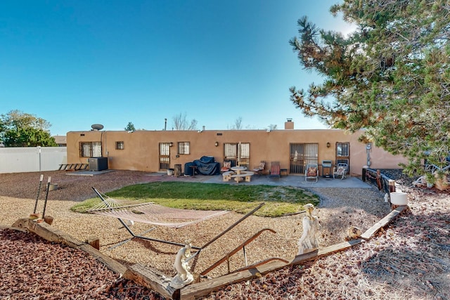 rear view of house featuring a lawn, a patio area, and cooling unit