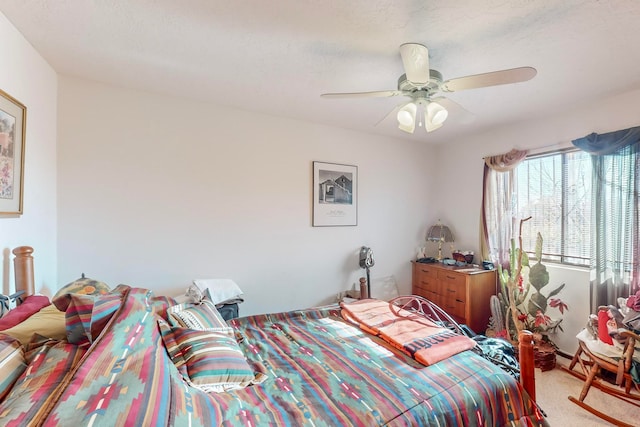 bedroom with ceiling fan and light colored carpet