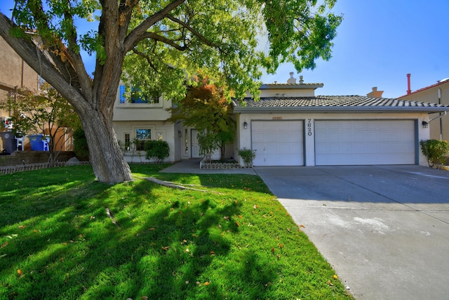 view of front of property featuring a garage and a front yard