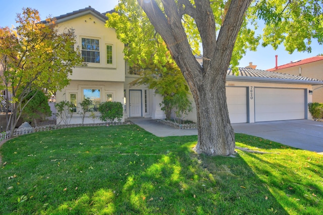 view of front facade featuring a front yard and a garage