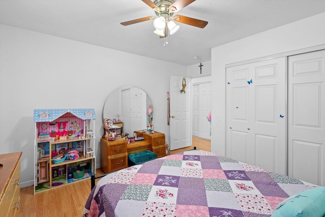 bedroom featuring hardwood / wood-style floors, a closet, and ceiling fan