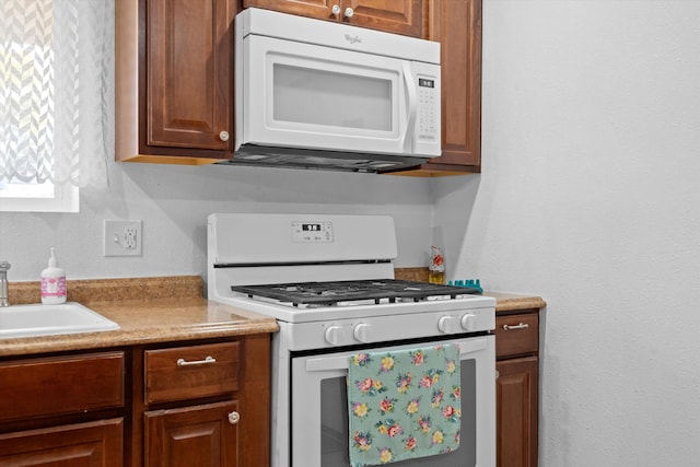 kitchen with white appliances and sink