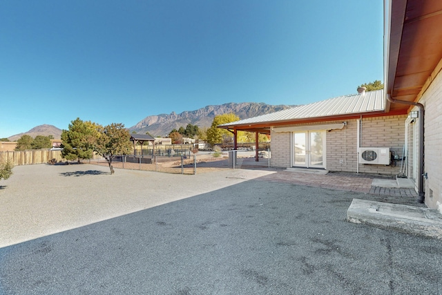 view of yard featuring a mountain view and ac unit