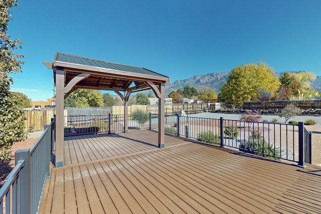 wooden deck featuring a gazebo and a water and mountain view